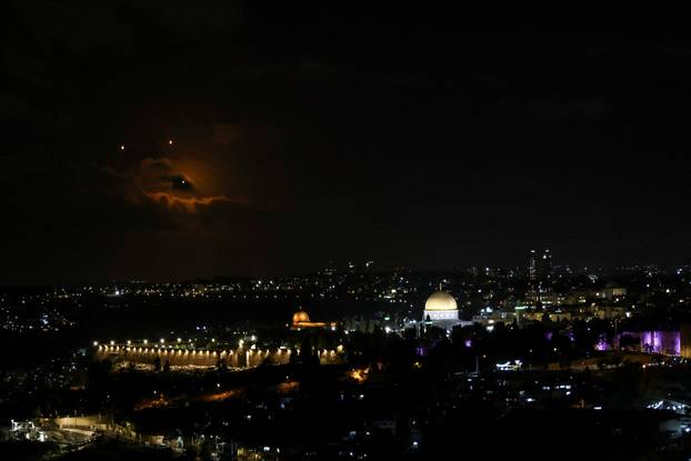 The Dome of the Rock on the Al-Aqsa compound, also known to Jews as the Temple Mount is seen as projectiles fly through the sky, after Iran fired a salvo of ballistic missiles at Israel, as seen from Jerusalem