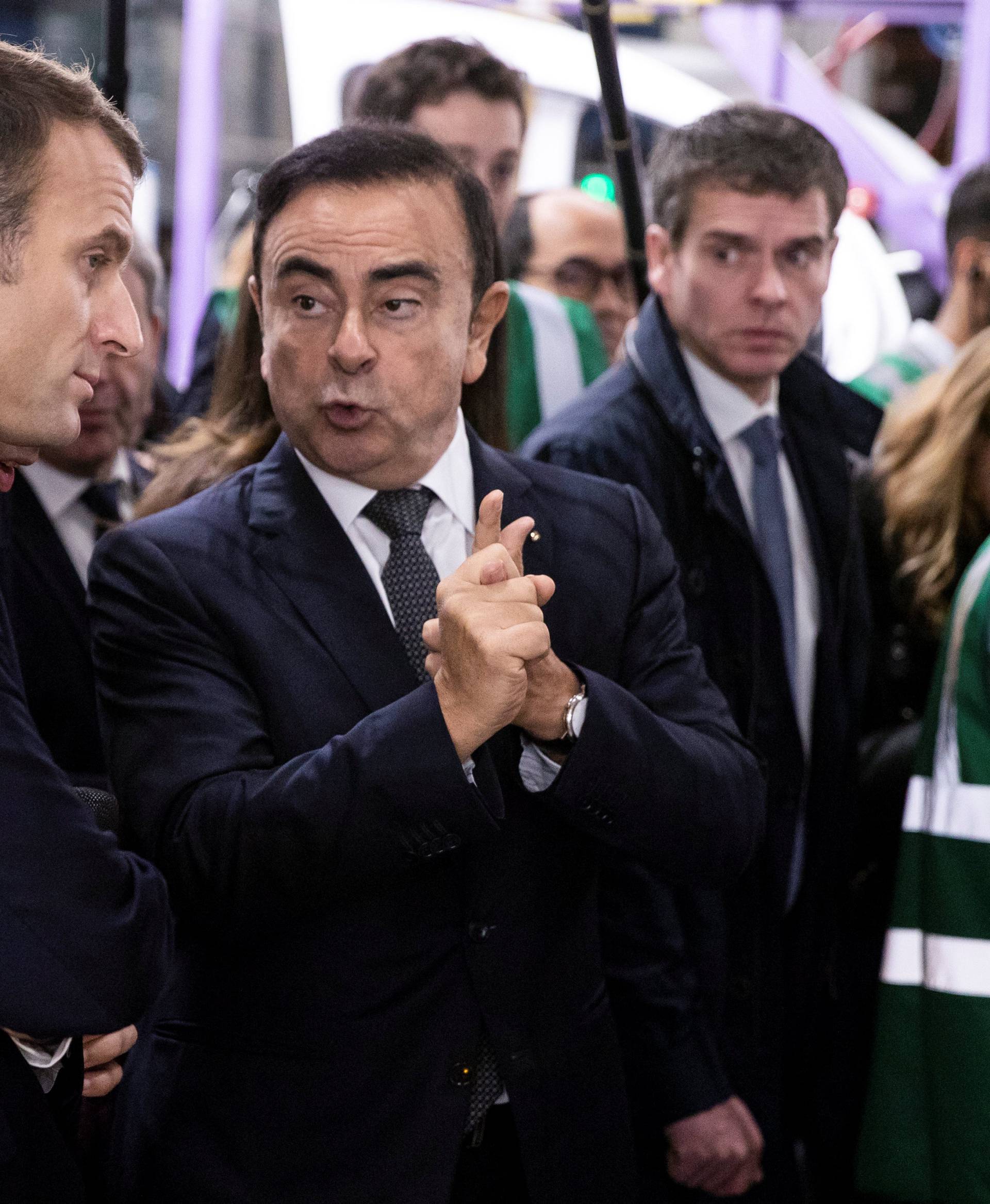 French President Emmanuel Macron discusses with Renault CEO Carlos Ghosn during a visit in the Renault factory in Maubeuge