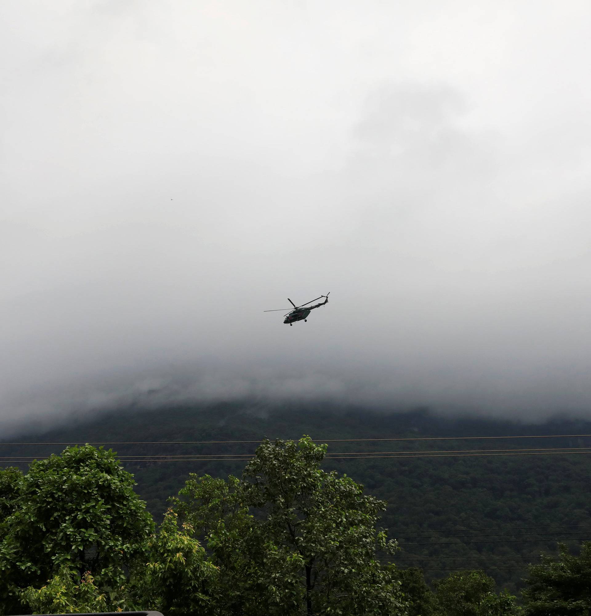 A military helicopter flies near flooded areas after the Xepian-Xe Nam Noy hydropower dam collapsed in Attapeu province