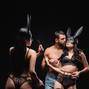 brunette woman in bunny mask holding flogging whip near lovers isolated on black