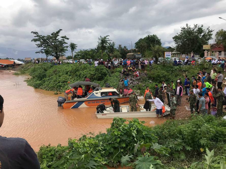 Rescuers work at a flooded site after a hydropower dam collapse in Attapeu Province