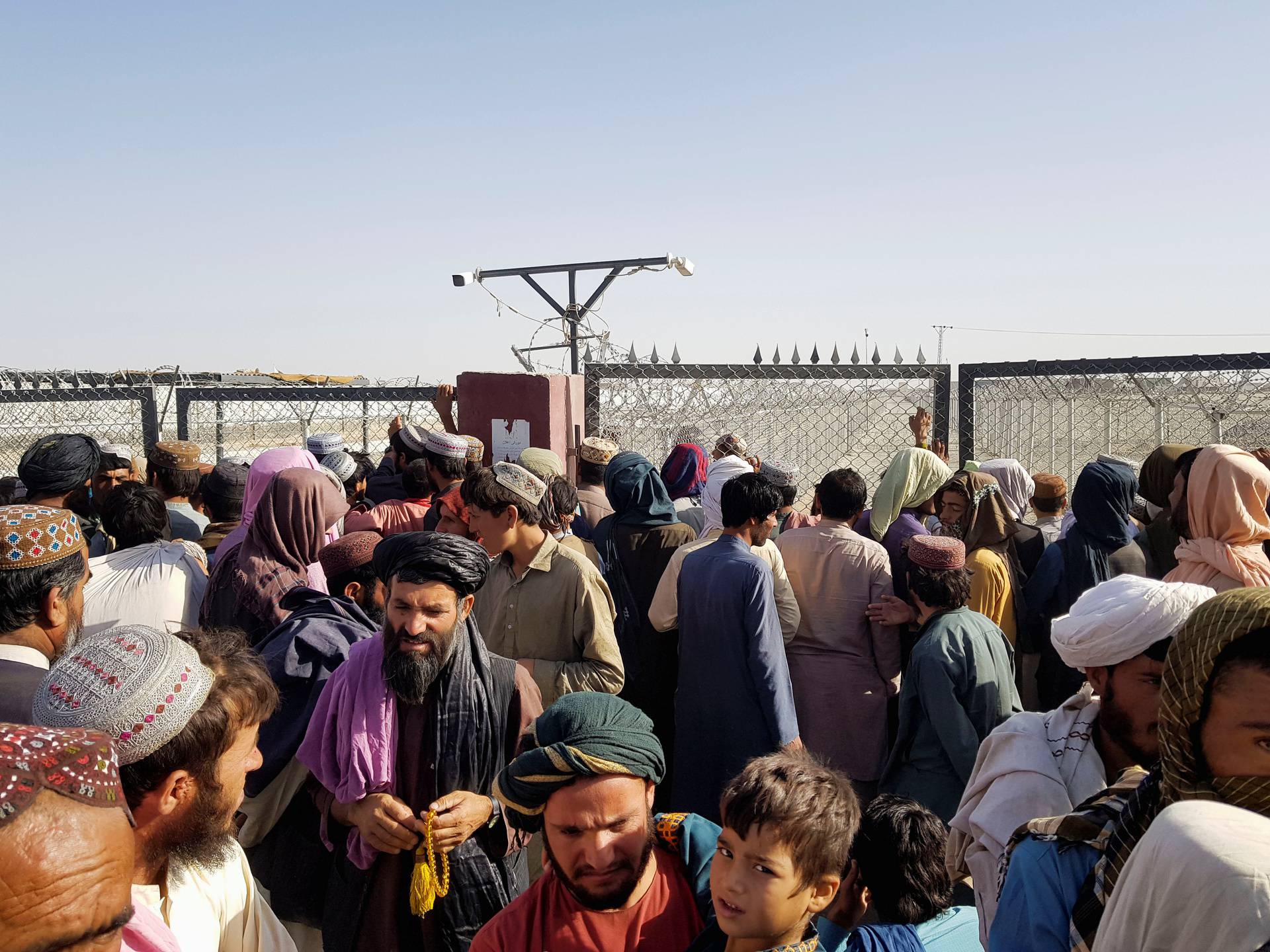 People gather as they wait to cross at the Friendship Gate crossing point in the Pakistan-Afghanistan border town of Chaman