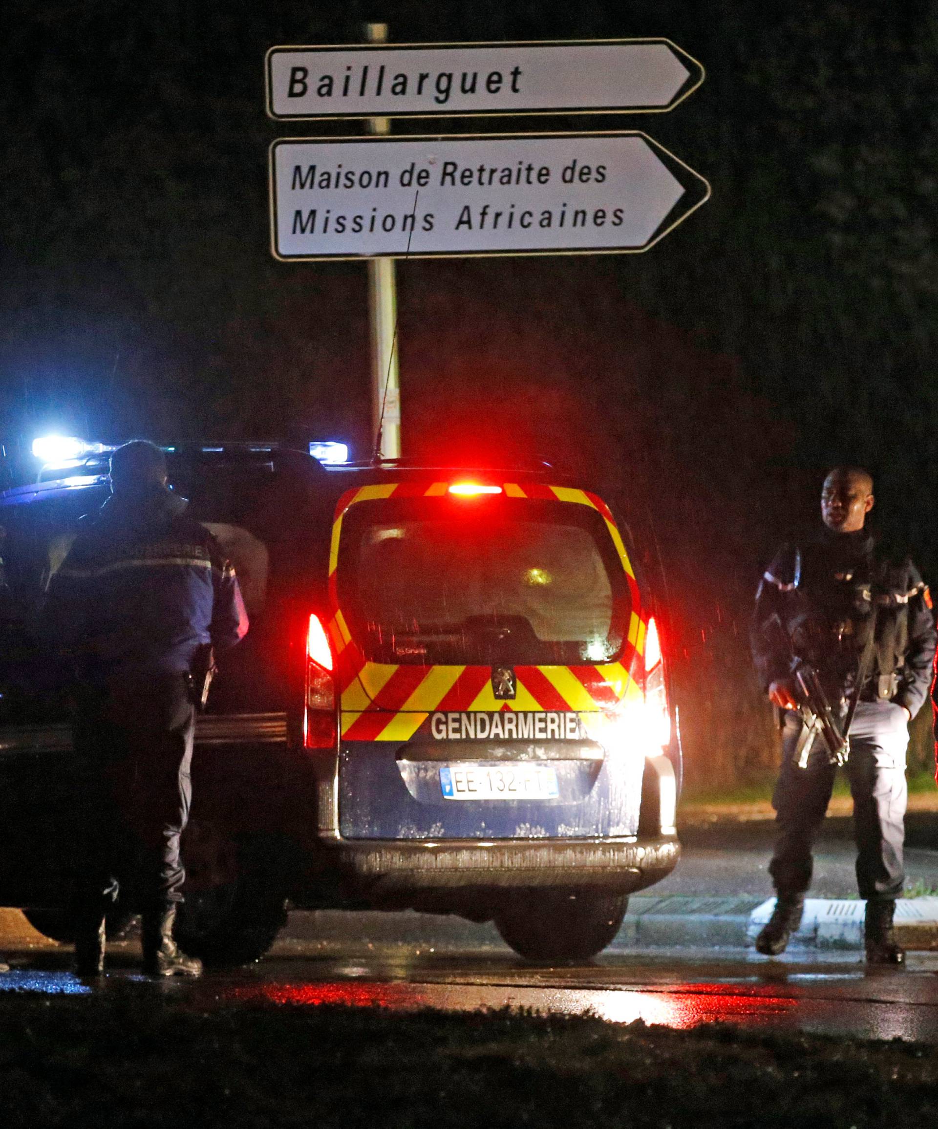 French gendarmes stand guard near a retirement home in Montferrier-sur-Lez, near Montpellier