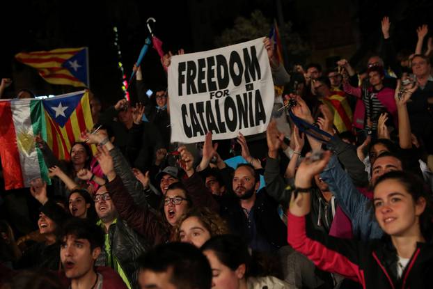 People react as they gather at Plaza Catalunya after voting ended for the banned independence referendum, in Barcelona