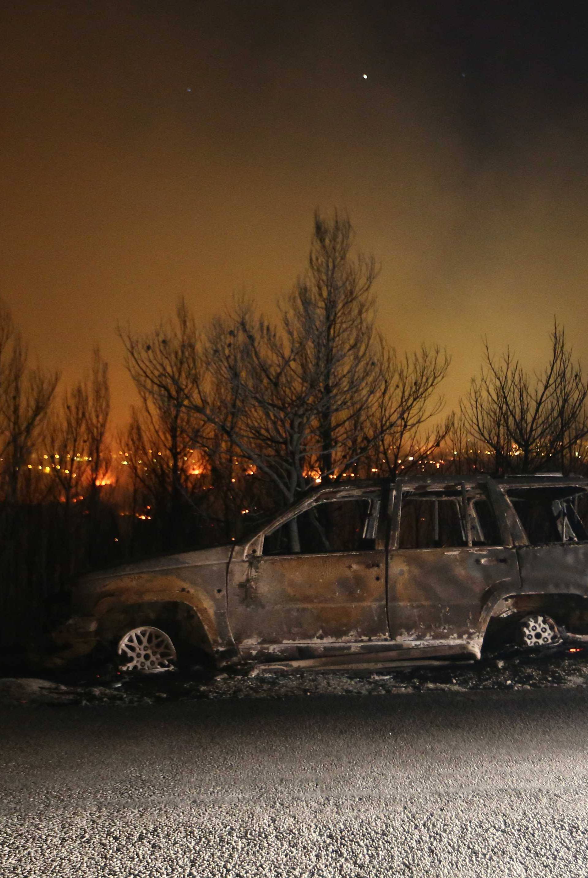 A car burned by the  wildfire is seen in the village of Mravince near Split