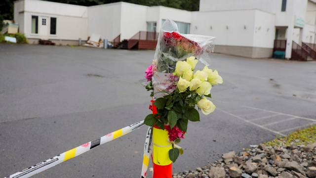 Flowers and a police tape are seem outside Al-Noor Islamic Centre Mosque, a day after a gunman's attack, in Baerum outside Oslo