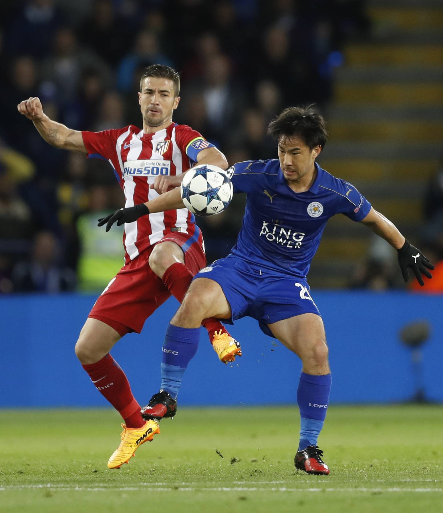 Atletico Madrid's Gabi in action with Leicester City's Shinji Okazaki