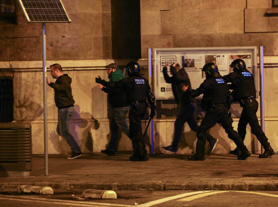 Protestors are dispersed by Catalan police during skirmishes after former regional president Carles Puigdemont was detained in Germany,  in Barcelona