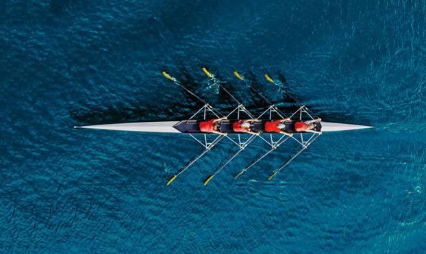 Women's,Rowing,Team,On,Blue,Water,,Top,View