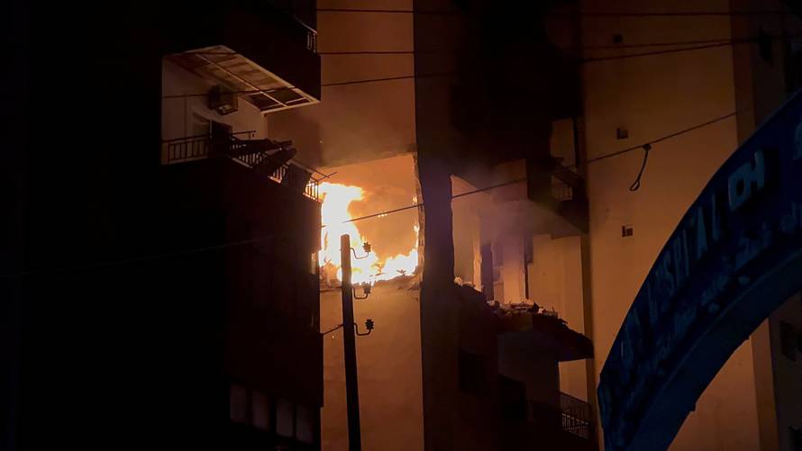 Fire burns at a building floor following an Israeli strike, in which the Israeli military said, it killed Hamas commander Hassan Farhat, in Sidon
