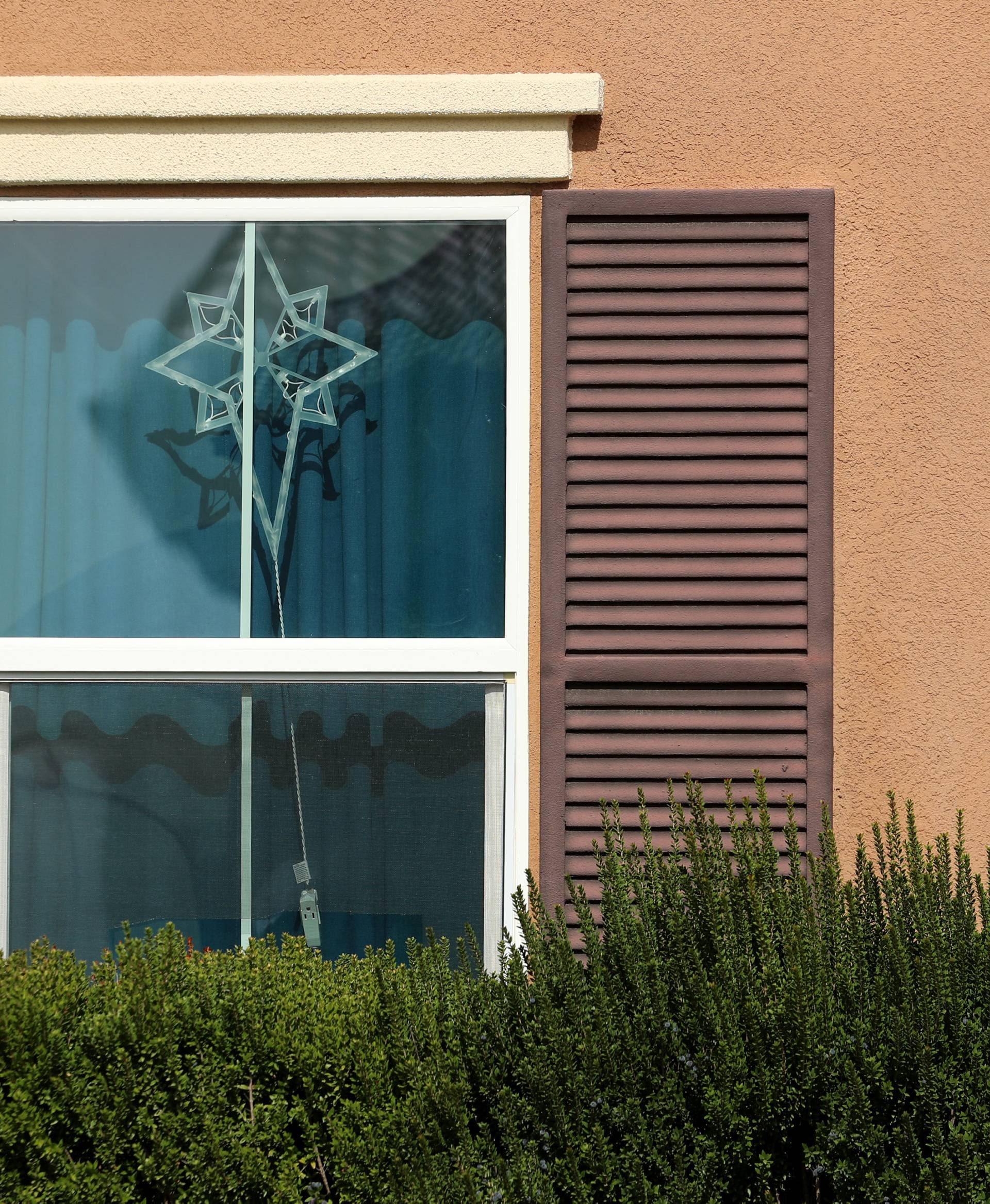 A decoration hangs in the window of the home of David Allen and Louise Anna Turpin in Perris