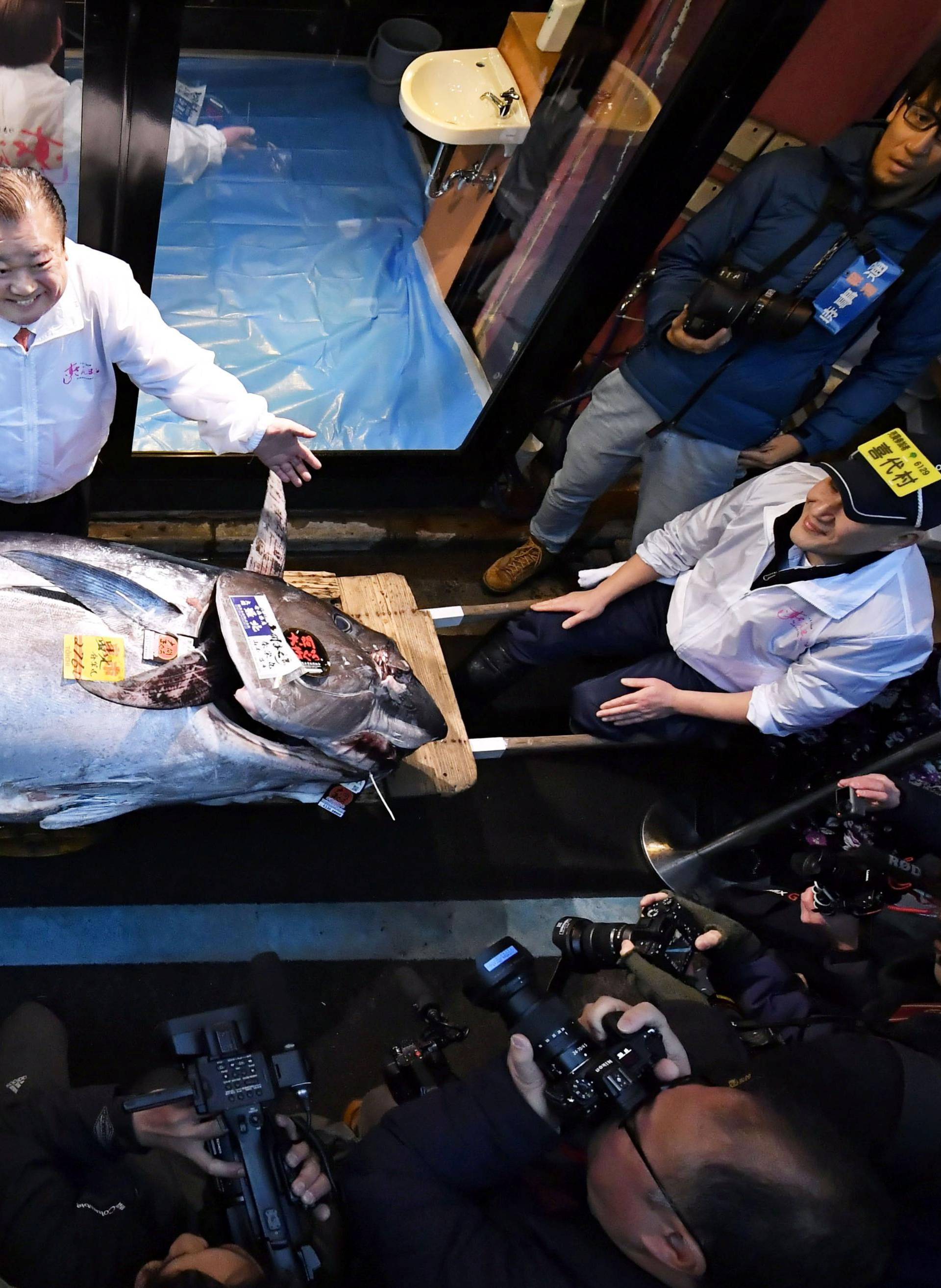 Kiyoshi Kimura, president of Kiyomura Corp., poses with a bluefin tuna in Tokyo