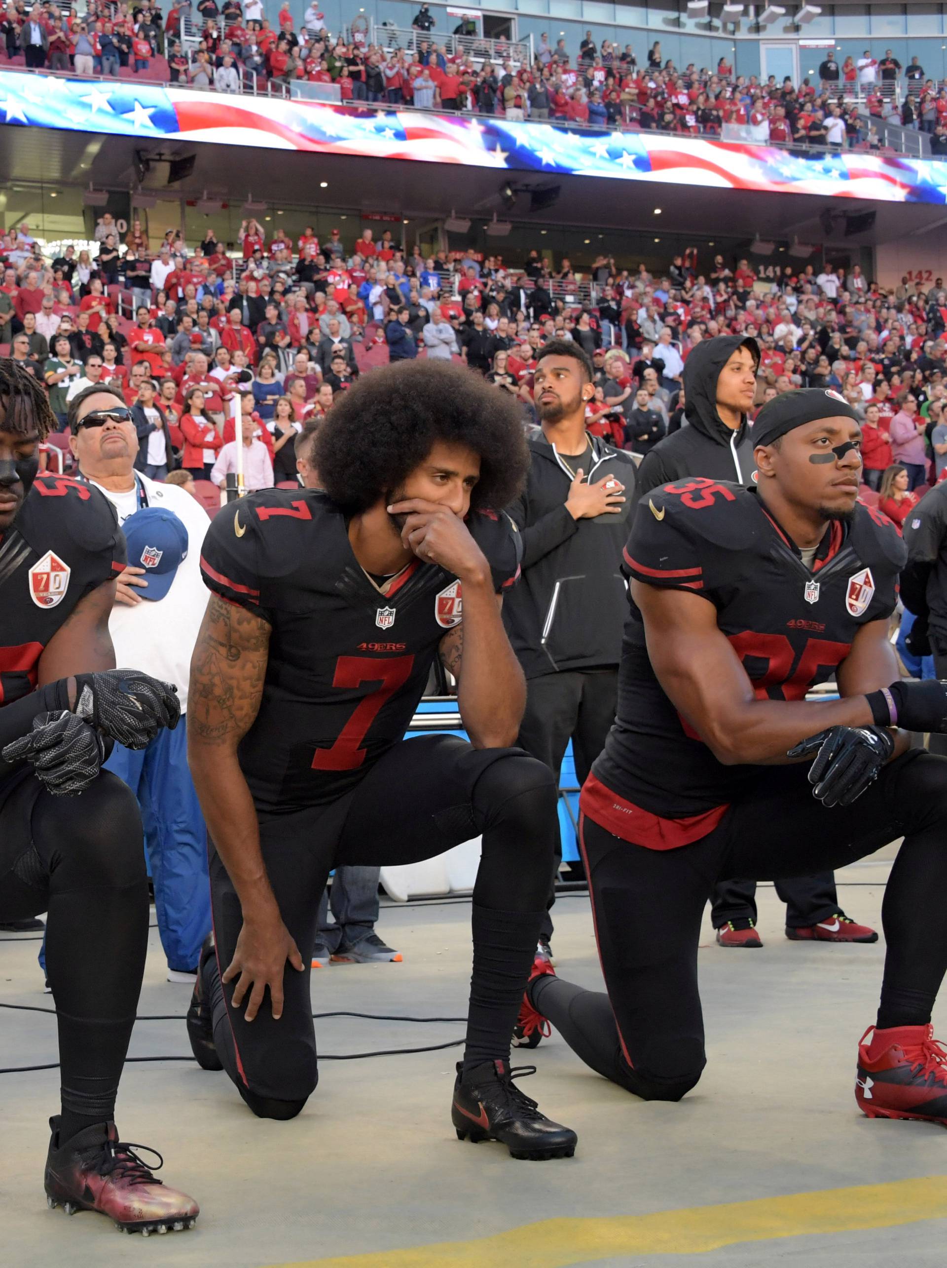 San Francisco 49ers outside linebacker Harold, quarterback Kaepernick and free safety Reid kneel in protest during the playing of the national anthem before a NFL game against the Arizona Cardinals in Santa Clara