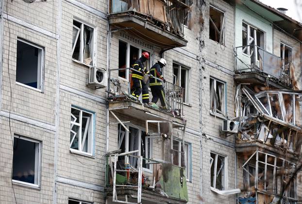 Emergency responders work at the site of a Russian drone strike on an apartment building, in Kyiv