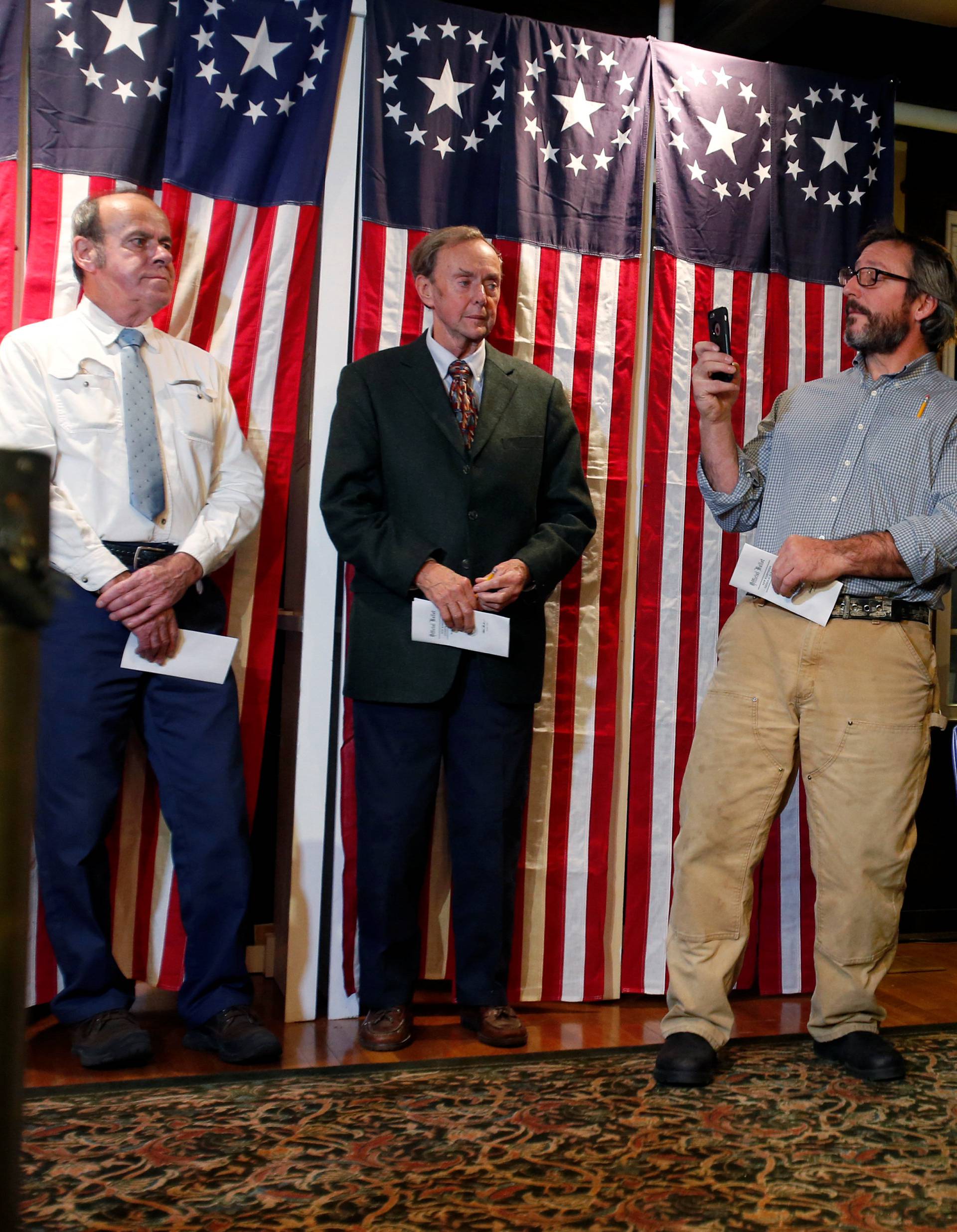 Russ Van Deursen takes a cell phone photo of the scene after filling out his ballot before casting it in the U.S. presidential election at midnight in tiny Dixville Notch