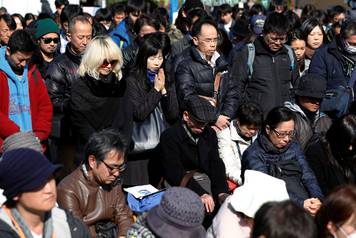 Participants observe a moment of silence at 2:46 p.m. (0546 GMT), the time when the magnitude 9.0 earthquake struck off Japan's coast in 2011, during a rally in Tokyo