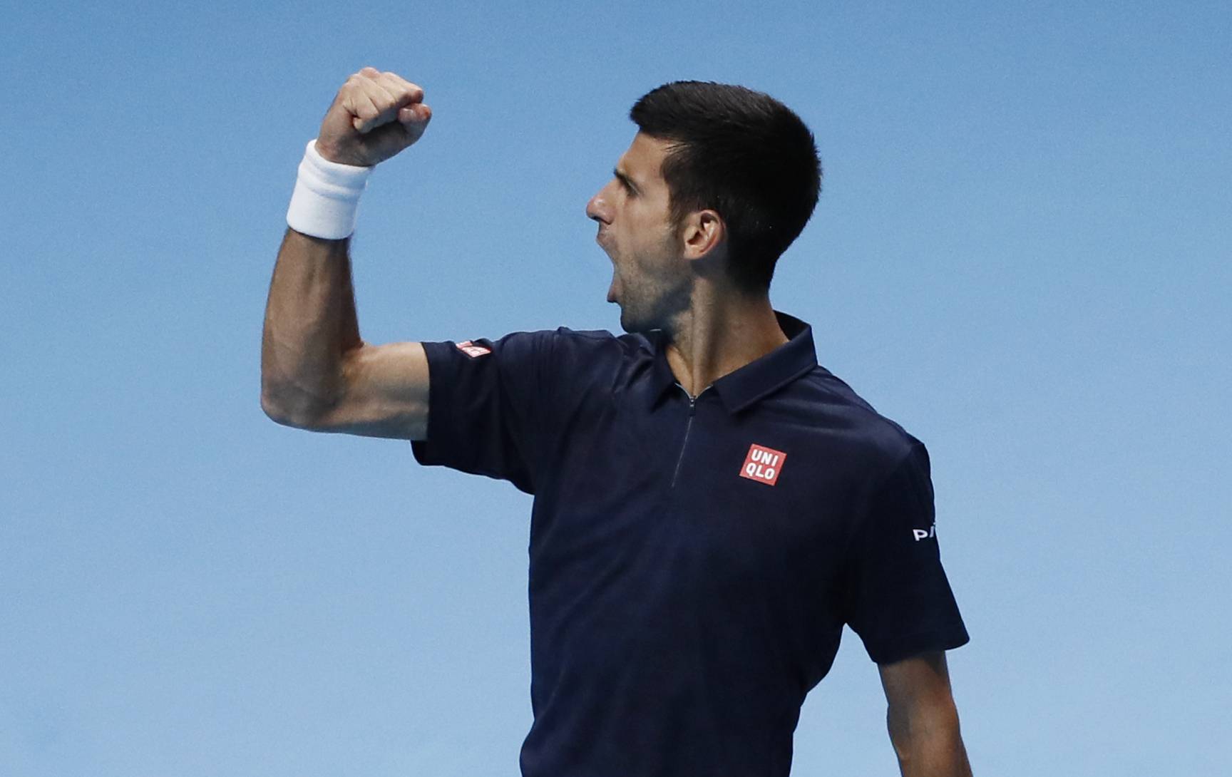 Serbia's Novak Djokovic celebrates winning the first set in his round robin match with Canada's Milos Raonic