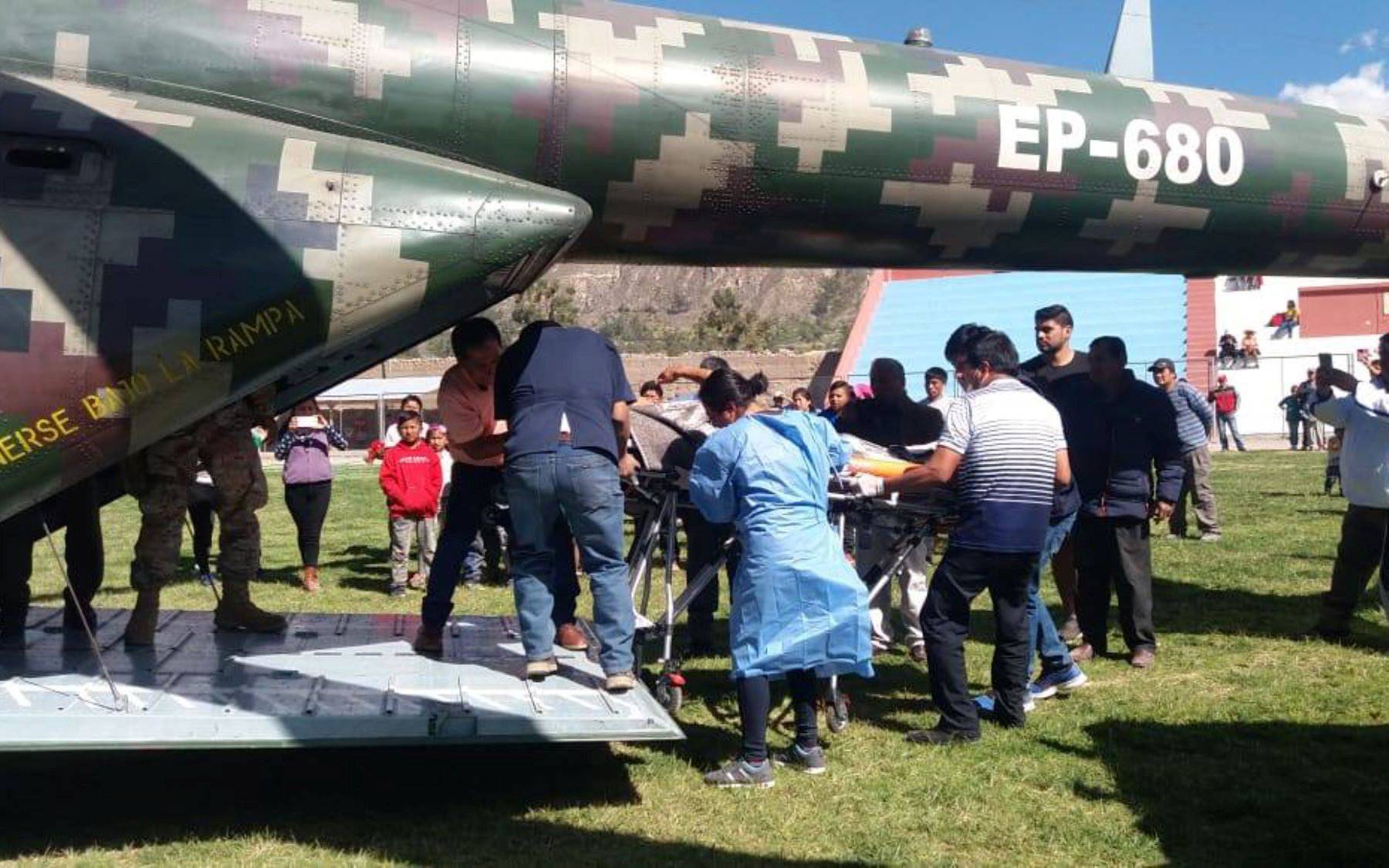 A person is transported to a helicopter after eating contaminated food at a funeral in the Peruvian Andes, in Ayacucho