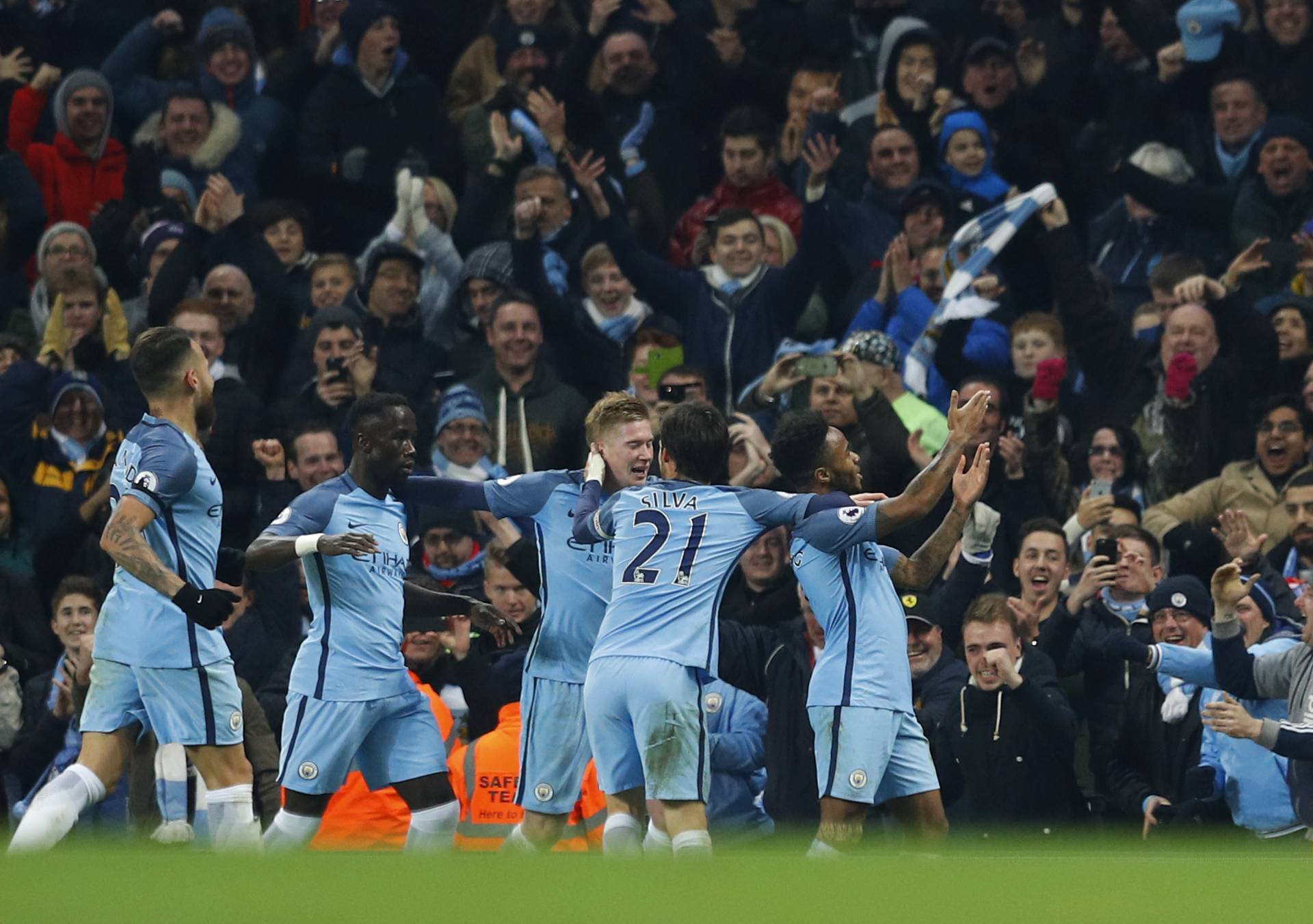 Manchester City's Raheem Sterling celebrates scoring their second goal with team mates