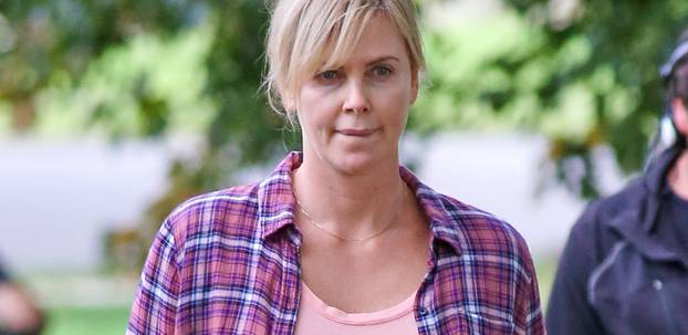 Charlize Theron puts her mothering skills to work while on the set of 