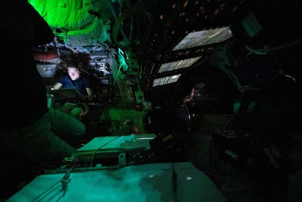 NASA astronaut Christina Koch is illuminated by a screen inside the darkened Orion spacecraft on the third day of the agency's Artemis II mission