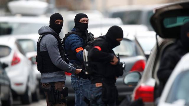 French special police forces secure a street during a police operation in the Neudorf district after the deadly shooting in Strasbourg