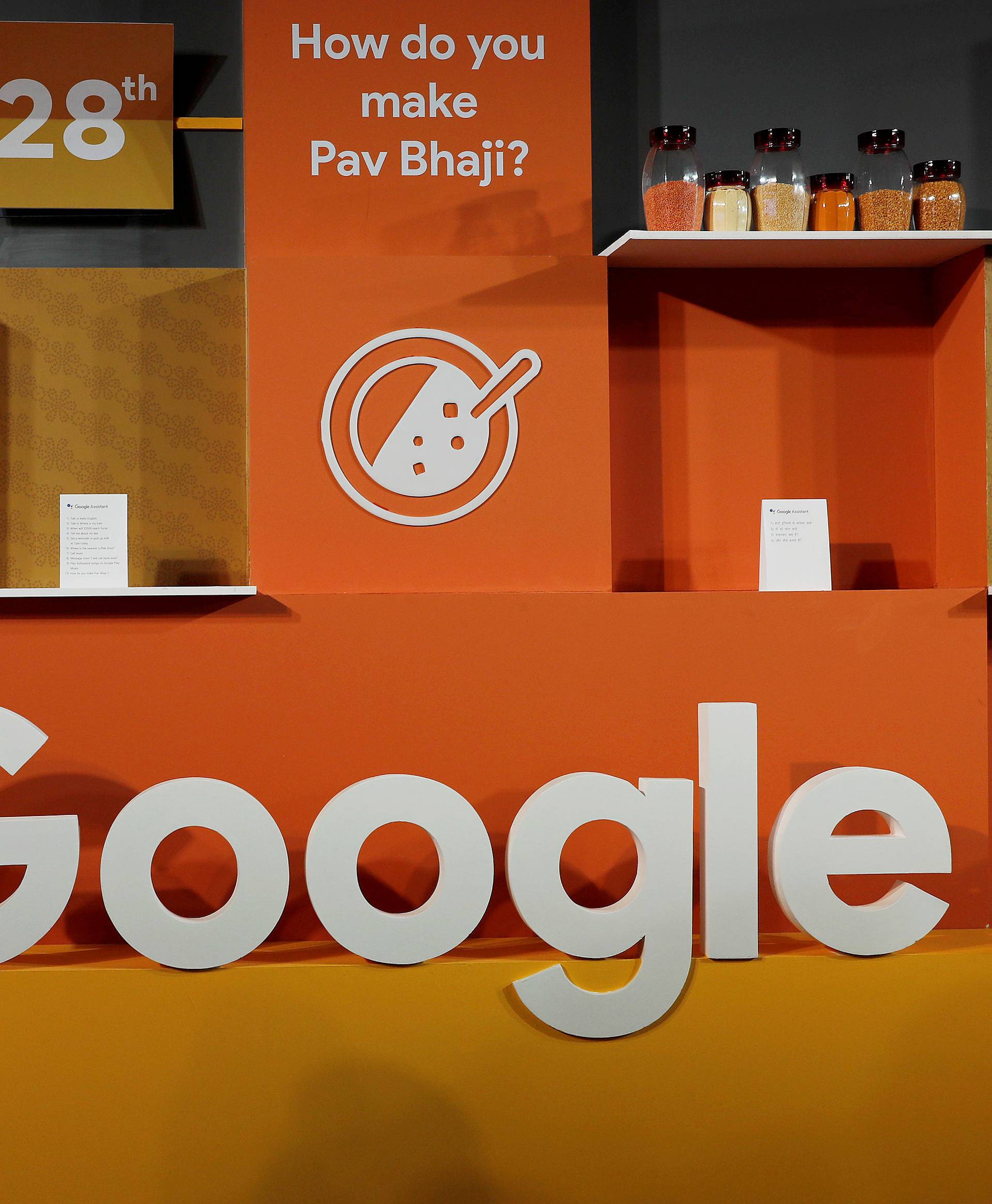 FILE PHOTO: A woman walks past the logo of Google during an event in New Delhi