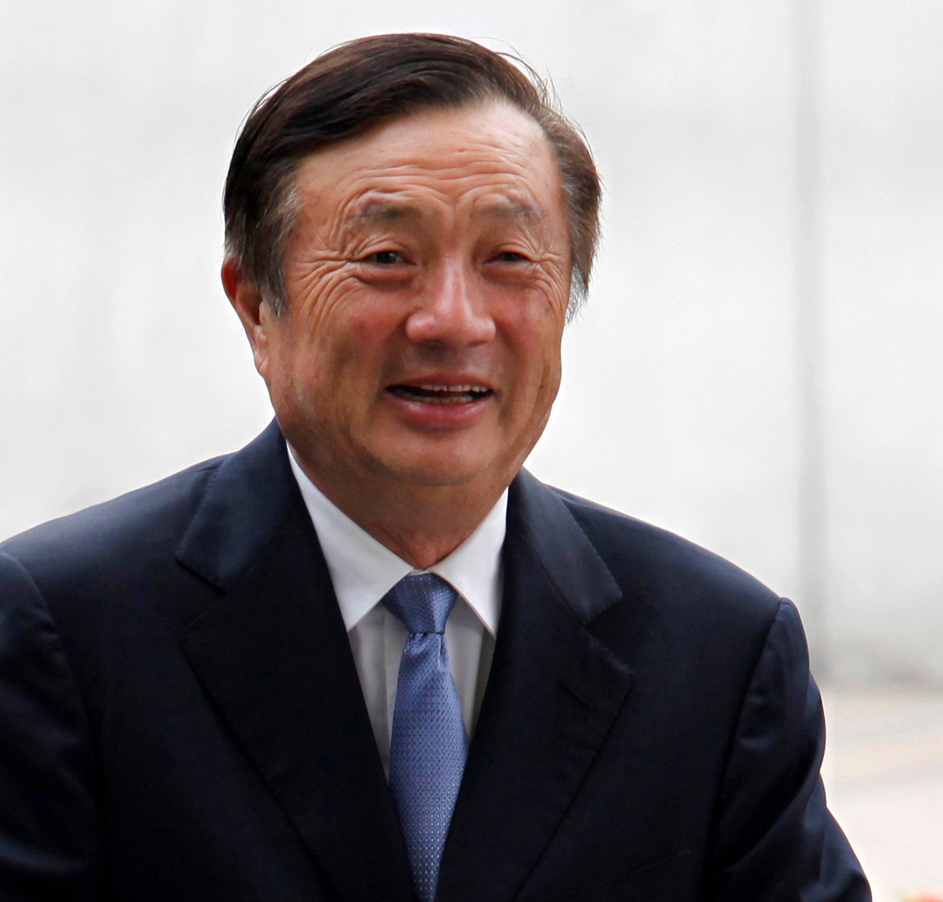 FILE PHOTO: Huawei CEO and founder Ren Zhengfei walks inside Huawei's headquarters in Shenzhen