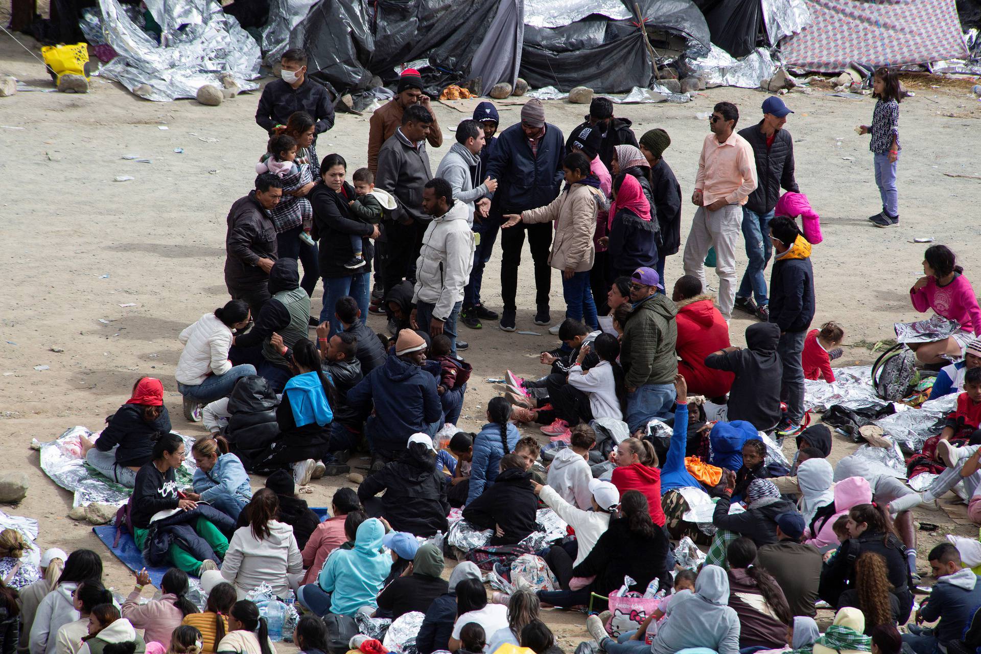 Migrants gather along the U.S.-Mexico border before the lifting of Title 42, as seen from Tijuana