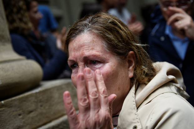 A woman reacts as she leaves a polling station after casting her vote for the banned separatist referendum in Barcelona