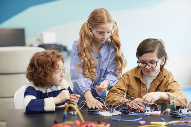 Front,View,Portrait,Of,Three,Children,Building,Robots,During,Engineering
