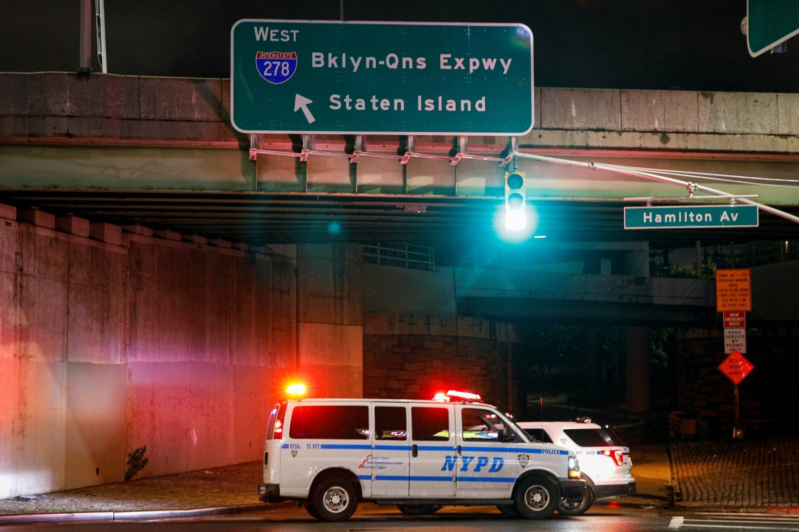 New York City Police vehicles block the entrance to the Brooklyn-Queens Expressway due to flooding in Brooklyn, New York