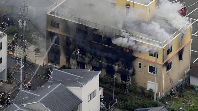 FILE PHOTO: FILE PHOTO : An aerial view shows firefighters battling fires at the site where a man started a fire after spraying a liquid at a three-story studio of Kyoto Animation Co. in Kyoto, western Japan, in this photo taken by Kyodo