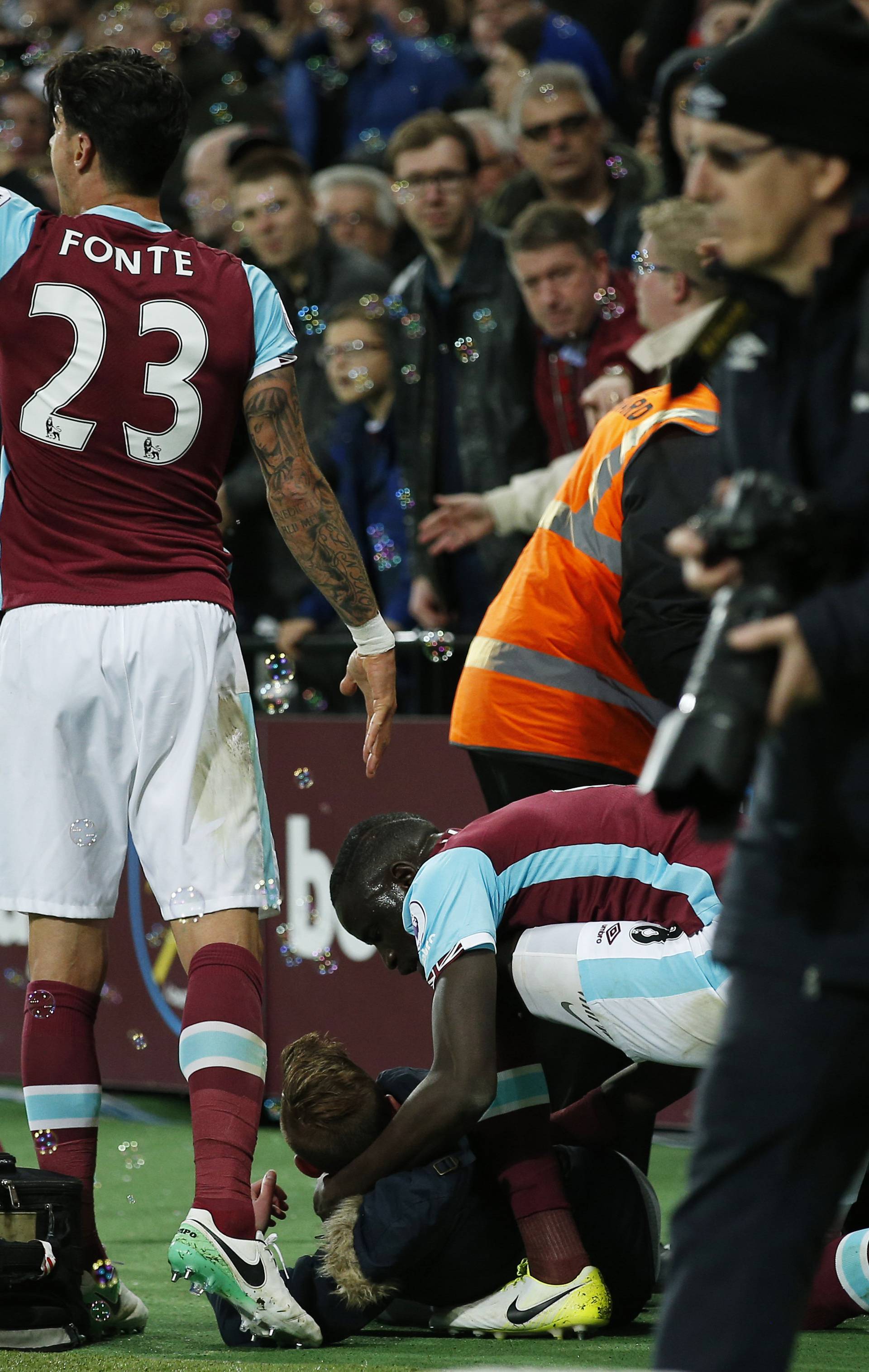 West Ham United's Cheikhou Kouyate with a fan after a barrier fell after West Ham United's Manuel Lanzini scored their first goal