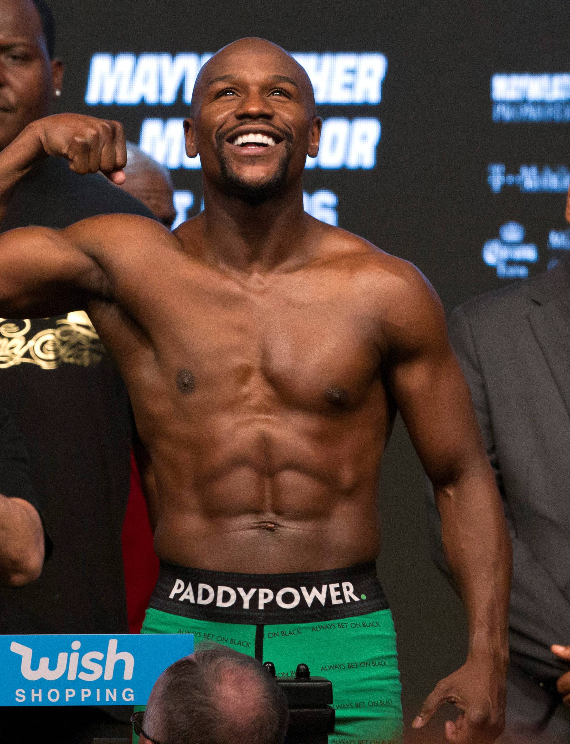 Undefeated boxer Floyd Mayweather Jr. of the U.S. poses in the scale during his official weigh-in at T-Mobile Arena in Las Vegas