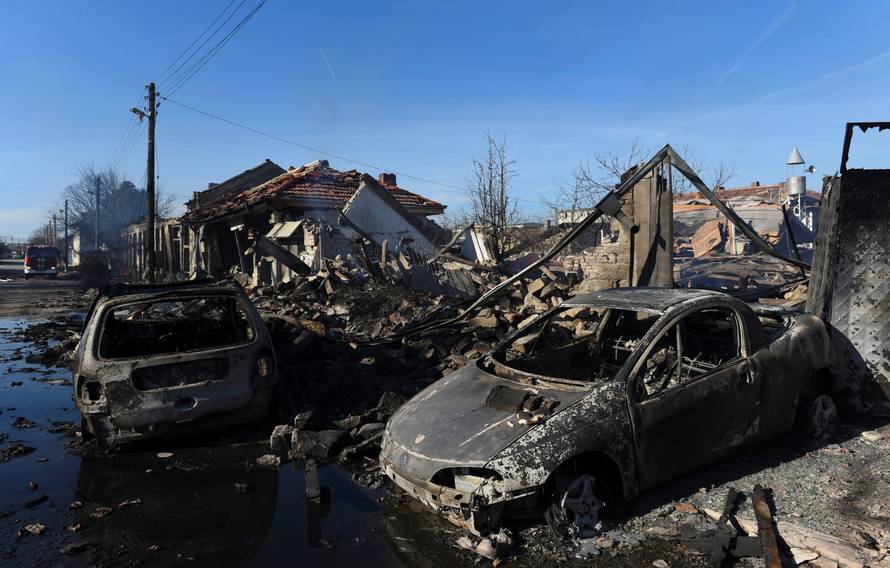 Damaged cars are seen after a cargo train derailed and exploded in the village of Hitrino