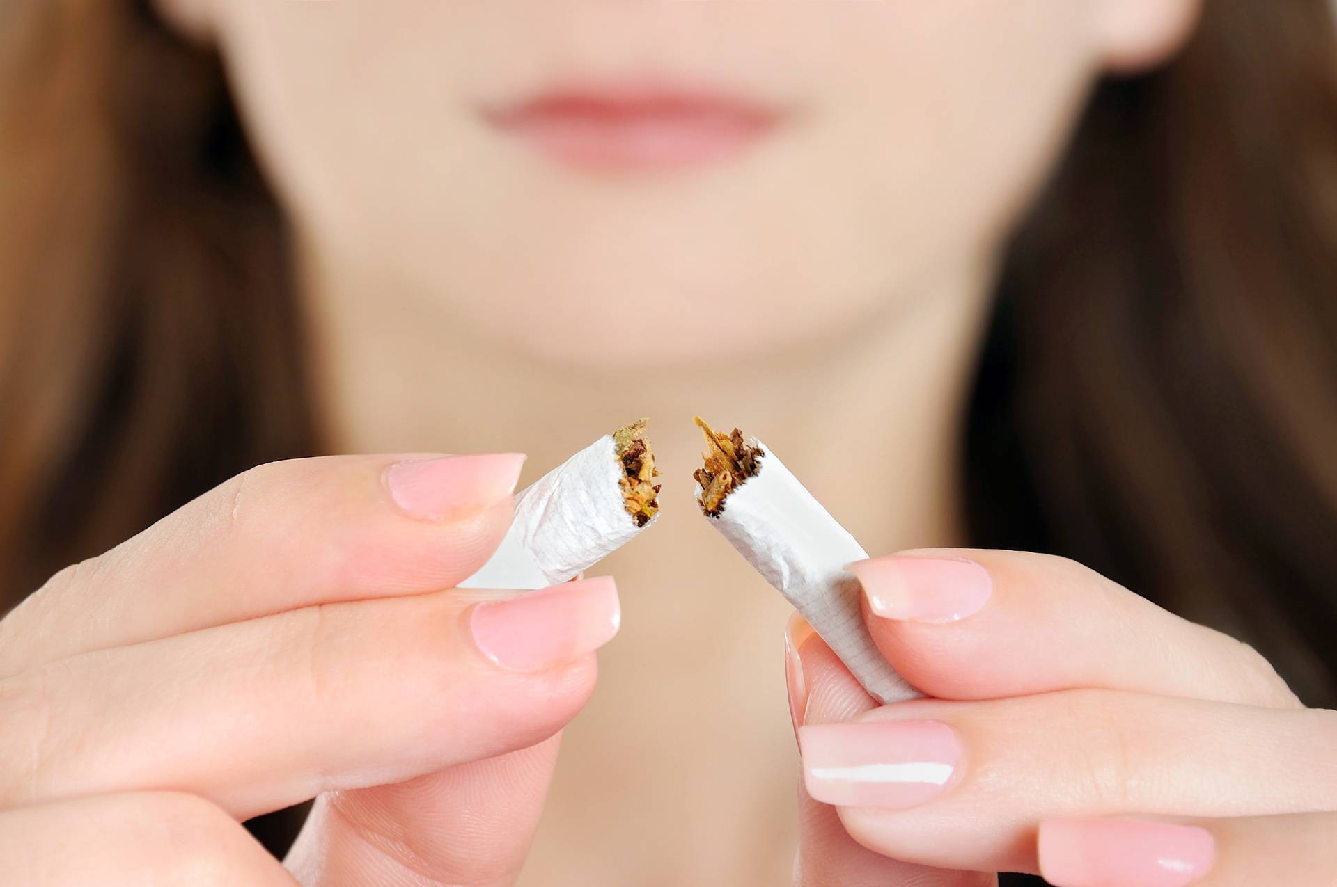 Woman breaking cigarette