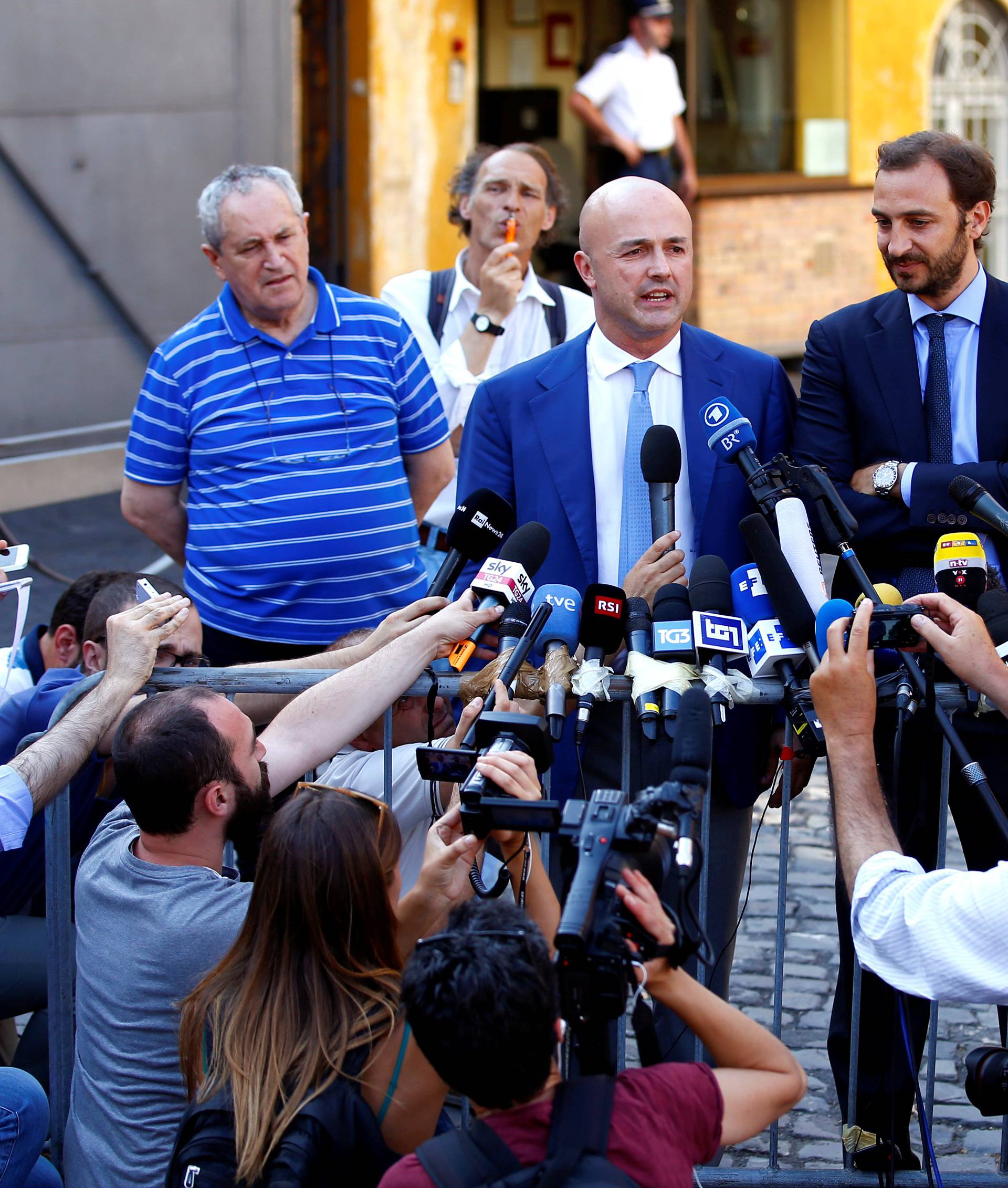 Journalists Fittipaldi and Nuzzi talk to reporters as they leave the Vatican at the end of their trial