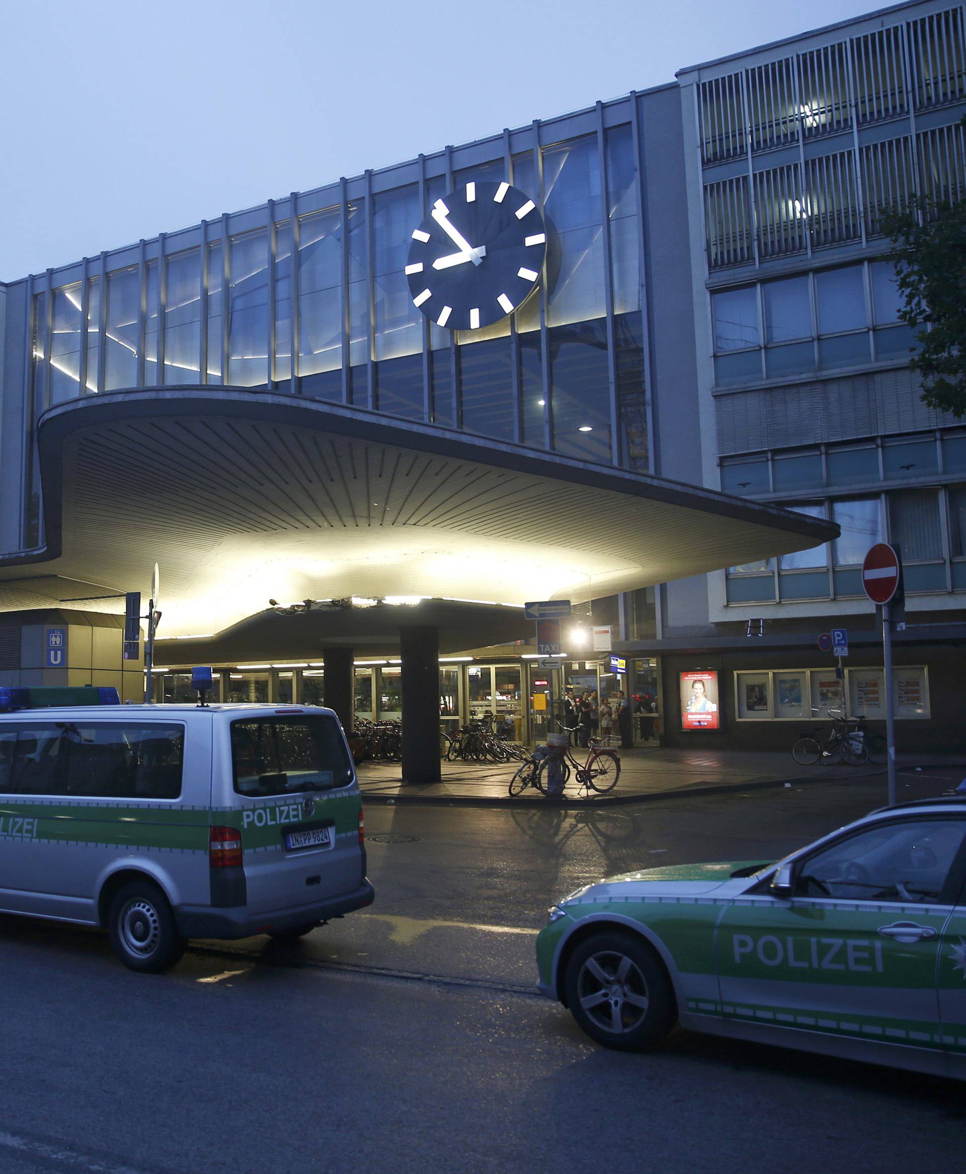 Police vehicles stand outside the main train station following shooting rampage at shopping mall in Munich