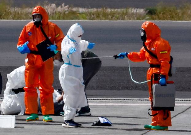 Passengers of the cruise ship MV Hondius, which was affected by a hantavirus outbreak, arrive at Tenerife Sud airport