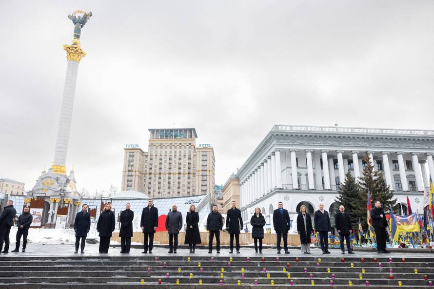 Ukraine's President Zelenskiy his wife Olena and foreign leader visit a makeshift memorial to fallen Ukrainian defenders at the Independent Square on the fourth anniversary of Russia's full-scale invasion, in Kyiv