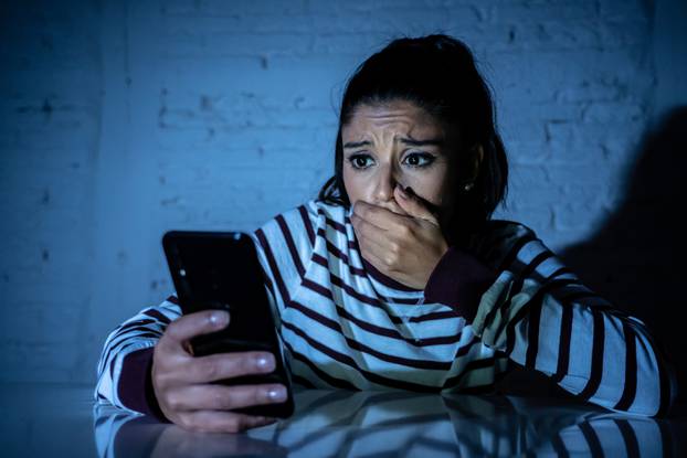 Frightened,Teenager,Or,Young,Woman,Using,Smart,Mobile,Cell,Phone