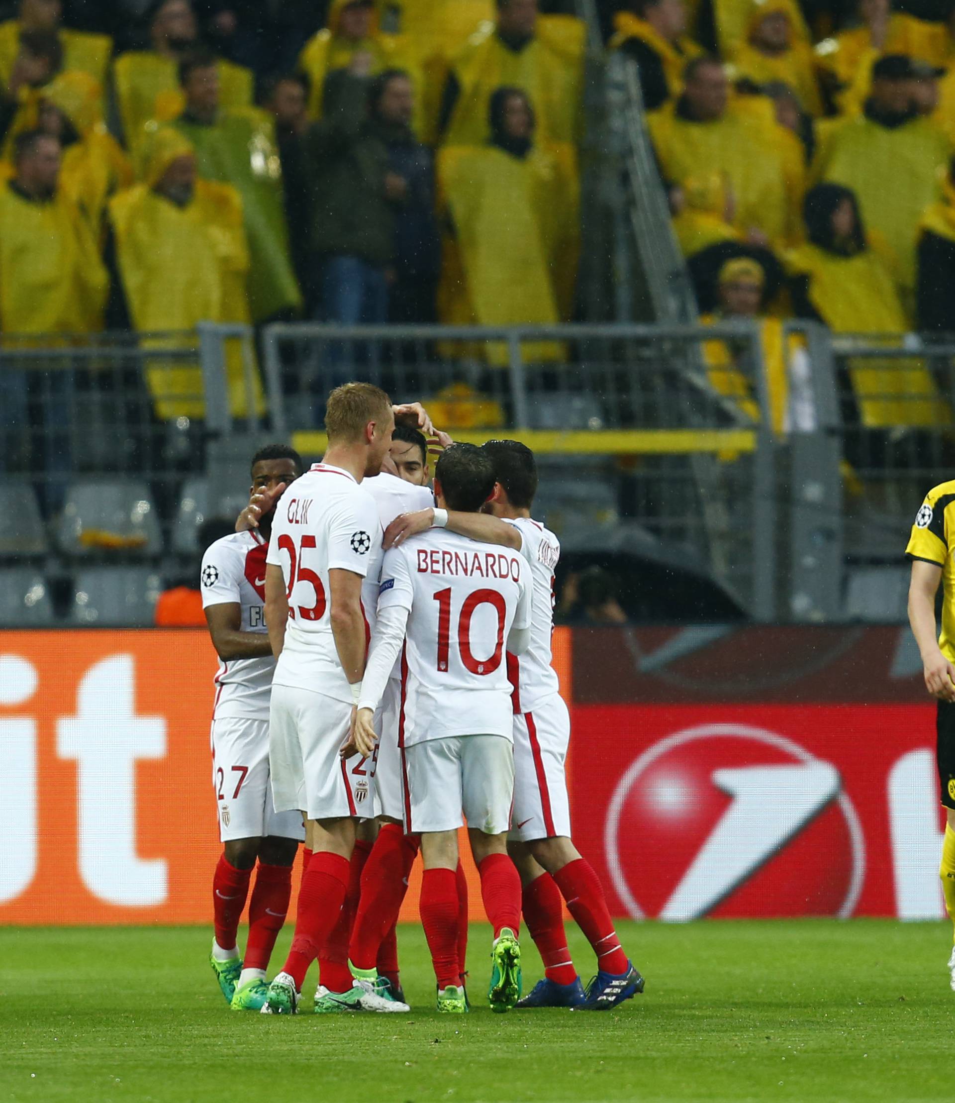 Monaco players celebrate after Borussia Dortmund's Sven Bender scored a own goal and their second as Borussia Dortmund's Matthias Ginter looks dejected