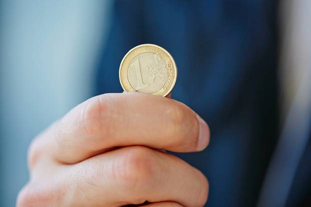 hand with euro coin