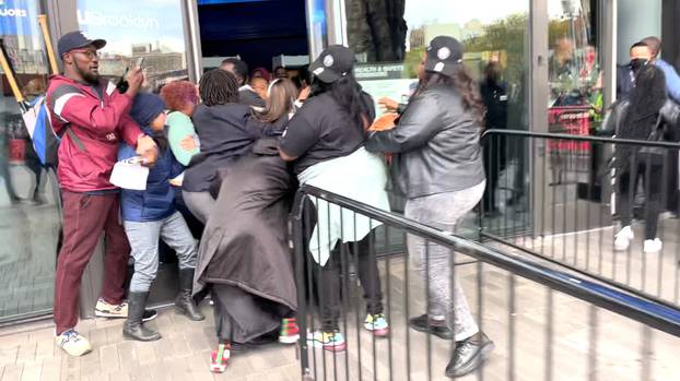 Demonstrators rush through the doors of the Barclays Center in New York