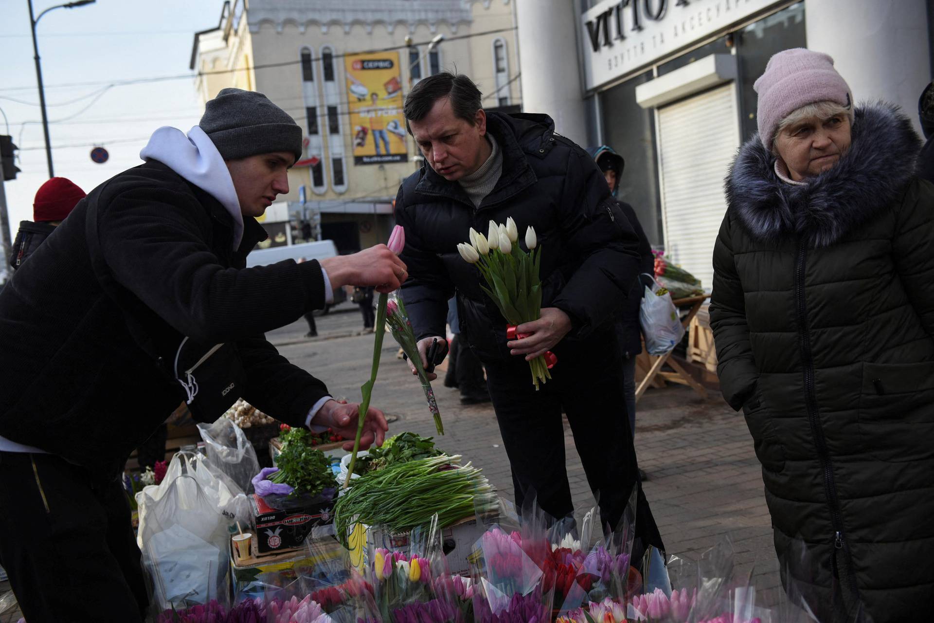 People buy flowers at a street market, amid Russia's invasion of Ukraine, in Odessa