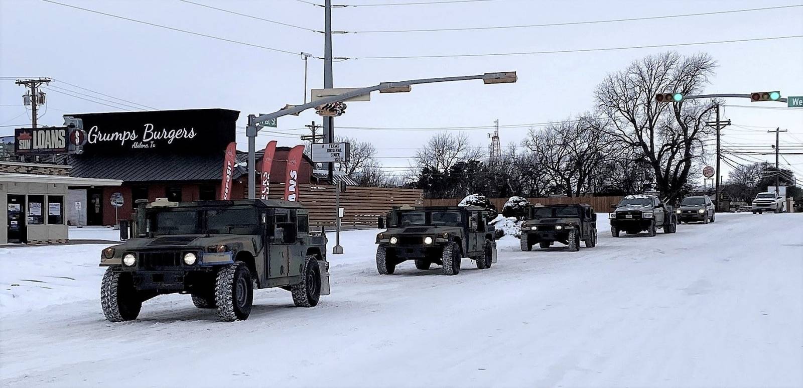 Military vehicles transport residents to designated warming centers in Abilene