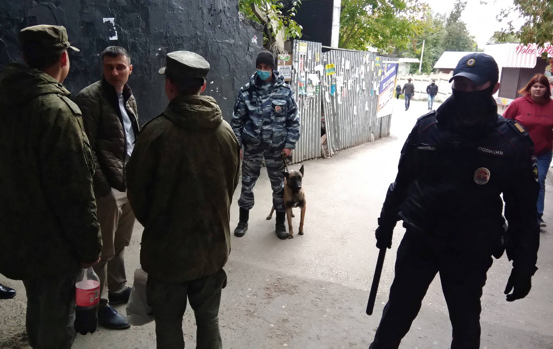 Law enforcement officers are seen near the scene of a shooting at university in Perm