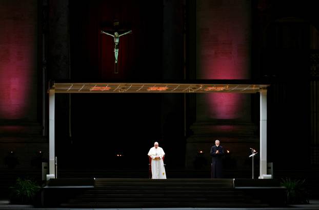 Pope Francis leads the Via Crucis (Way of the Cross) procession during Good Friday celebrations at the Vatican