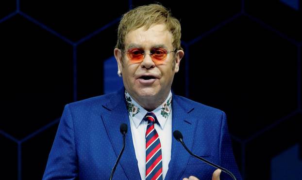 Singer Elton John speaks after receiving a Crystal Award from Hilde Schwab, Chairperson and Co-Founder, Schwab Foundation for Social Entrepreneurship, during the World Economic Forum (WEF) annual meeting in Davos